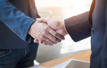 Two confident business man shaking hands during meeting in the office success dealing greeting and partner concept - Attribut alt par défaut.